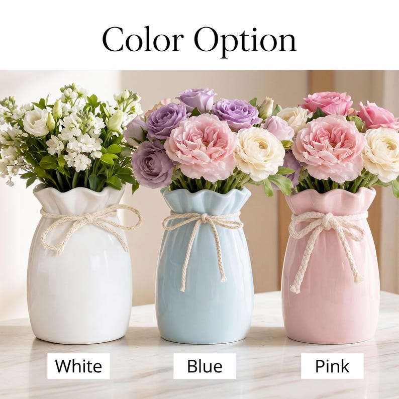 May include: Three ceramic vases in white, blue, and pink, each holding a bouquet of flowers. The vases have a ruffled top and a tied rope detail. The text "Color Option" is at the top, with "White", "Blue", and "Pink" below the vases.