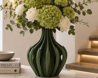May include: A dark green 3D printed vase with a ribbed, vertical leaf-like texture. The vase holds a large arrangement of green hydrangeas, white peonies, and thin leafy branches. A text box in the corner reads 3D PRINTED Premium PLA Not Ceramic.