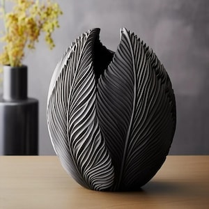 May include: A black ceramic vase with a unique design featuring a series of overlapping, textured leaves. The vase is round and has a wide opening at the top.