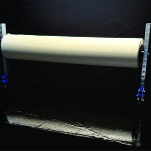 May include: A white roll of paper is mounted on a metal stand with blue clamps. The stand has a silver finish and is designed to hold a roll of paper.