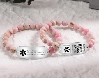May include: Two beaded bracelets with pink and cream-colored stones. Each bracelet features a silver tag with a medical symbol. One tag includes text: "Type 2 Diabetes" and medical codes. The other tag has a QR code and the words "Health Info" and "Scan Me."