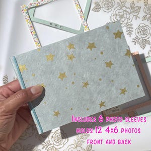 4 x 6 mini photo album, gold stars over light blue, thin, flat, chipboard/cereal box, landscape