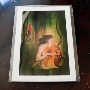 May include: A woman with long brown hair is looking at a red and brown pitcher plant. The plant is hanging from the ceiling and the woman is reaching out to touch it. The background is a dark green and brown.