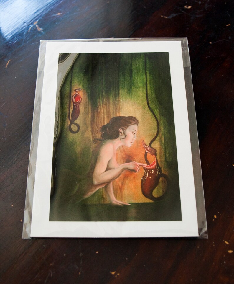 May include: A woman with long brown hair is looking at a red and brown pitcher plant. The plant is hanging from the ceiling and the woman is reaching out to touch it. The background is a dark green and brown.