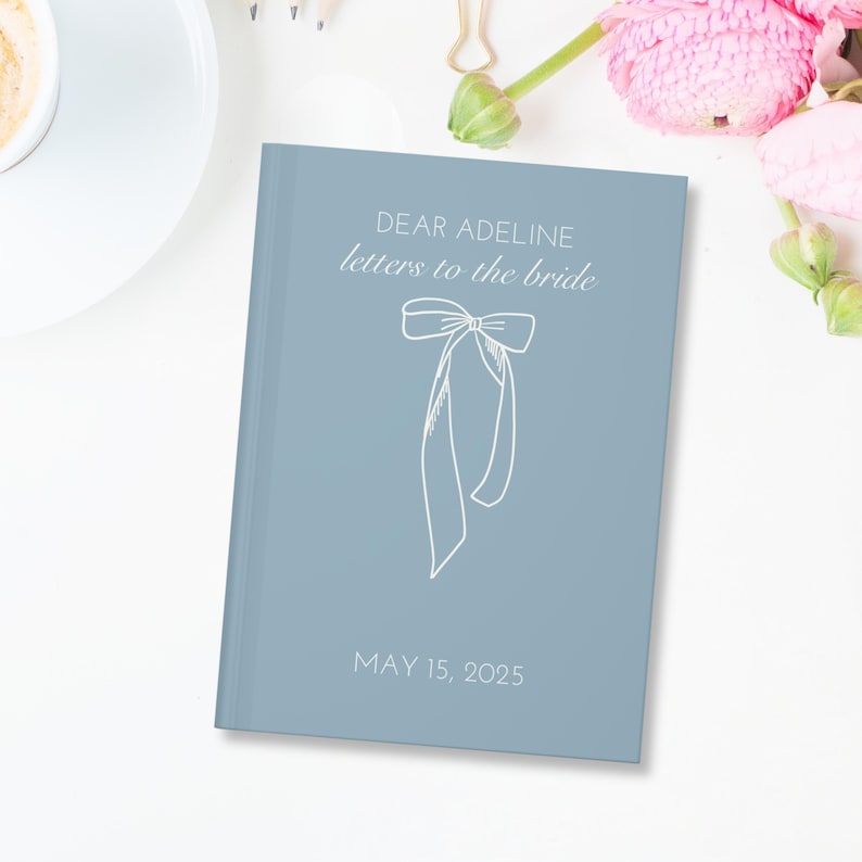 May include: A light blue journal with the text "Dear Adeline letters to the bride" and a white bow illustration. The date "May 15, 2025" is printed at the bottom.