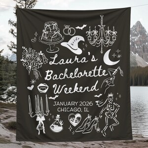 May include: Black fabric banner with white illustrations and text. The banner reads "Laura's Bachelorette Weekend, January 2026, Chicago, IL." Illustrations include a cake, rings, a witch hat, a chandelier, a moon, and high heels.