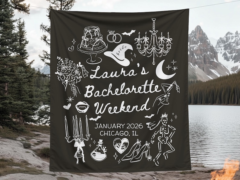 May include: Black fabric banner with white illustrations and text. The banner reads "Laura's Bachelorette Weekend, January 2026, Chicago, IL." Illustrations include a cake, rings, a witch hat, a chandelier, a moon, and high heels.