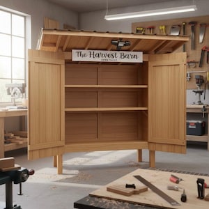 Puede incluir: Un armario de madera con techo inclinado y dos puertas abiertas, que revelan estantes. El letrero sobre las puertas dice "The Harvest Barn OPEN DAILY". El armario est&aacute; en un taller con herramientas visibles.