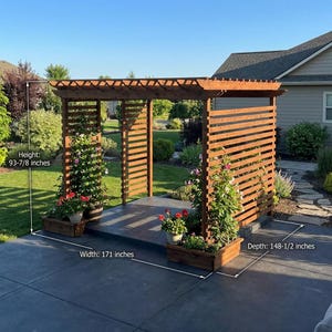 May include: A wooden pergola with a slatted side panel and a flat roof. The structure is 238.4 cm high, 434.3 cm wide, and 377.2 cm deep. It features planters with flowers and is set on a concrete patio.