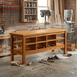 May include: A wooden workbench, dimensions: height 41 cm, width 104 cm, depth 37 cm. The workbench features two shelves with compartments. Various woodworking tools are placed on the surface, suggesting a workshop setting.
