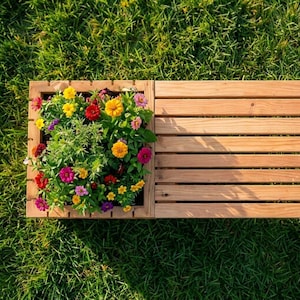 May include: A wooden planter box with a built-in bench. The planter is filled with colorful flowers in shades of red, yellow, pink, and purple. The bench is made of light-colored wood and has a slatted design. The scene is set on a bed of green grass.