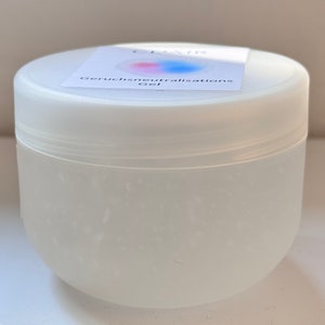 Puede incluir: Un tarro de plástico blanco con un gel transparente en su interior. La etiqueta del tarro dice "Geruchsneutralisations Gel".