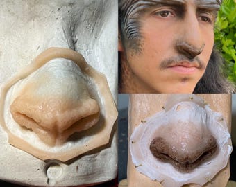 May include: A prosthetic nose made of flesh-toned silicone, displayed in a mold and on a person's face. The nose has a realistic shape and texture, with subtle color variations. The image also shows a person with makeup.