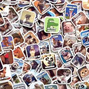 May include: A selection of square stickers featuring animal illustrations and German text. The stickers depict various animals, including dogs, cats, and pandas, with speech bubbles and humorous phrases. The stickers are brightly coloured and have a playful design.