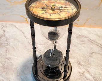 Reloj de arena de latón con arena negra y doble brújula de 18 cm.