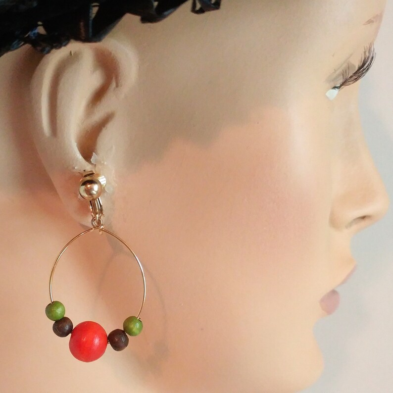 Mod 1960s wood beaded wire earrings dangle hoop earrings black orange and olive green beads gold tone boho hippie jewelry clip on earrings