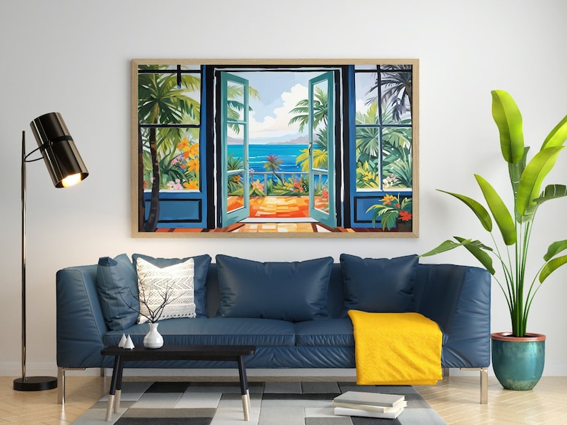May include: A framed painting of an open door with a view of a tropical beach scene. The painting is hanging on a white wall above a blue sofa with a yellow throw blanket.