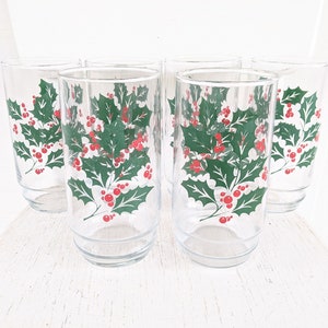 May include: Set of six clear glass drinking glasses with a holly and berry design. The glasses are perfect for holiday entertaining.