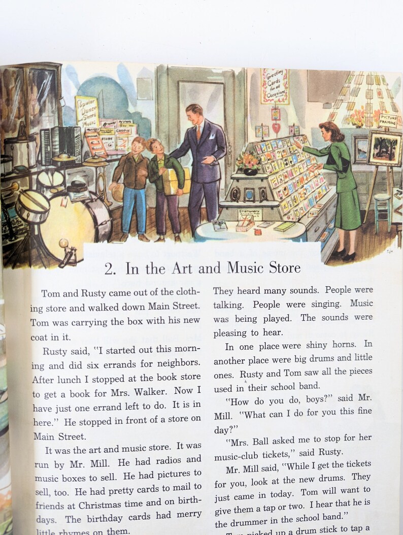 May include: Two children are shopping in a music store. The store has a variety of musical instruments, including drums, horns, and music boxes. The store also sells greeting cards and pictures. The text on the sign above the greeting cards reads "Greeting Cards for all Occasions".