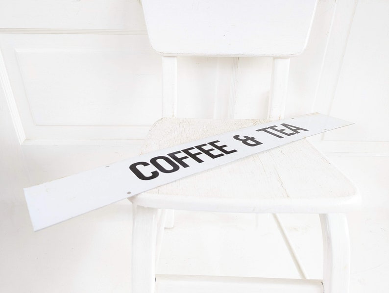 Puede incluir: Silla de madera blanca con un letrero blanco que dice "Coffee & Tea" en la parte superior.