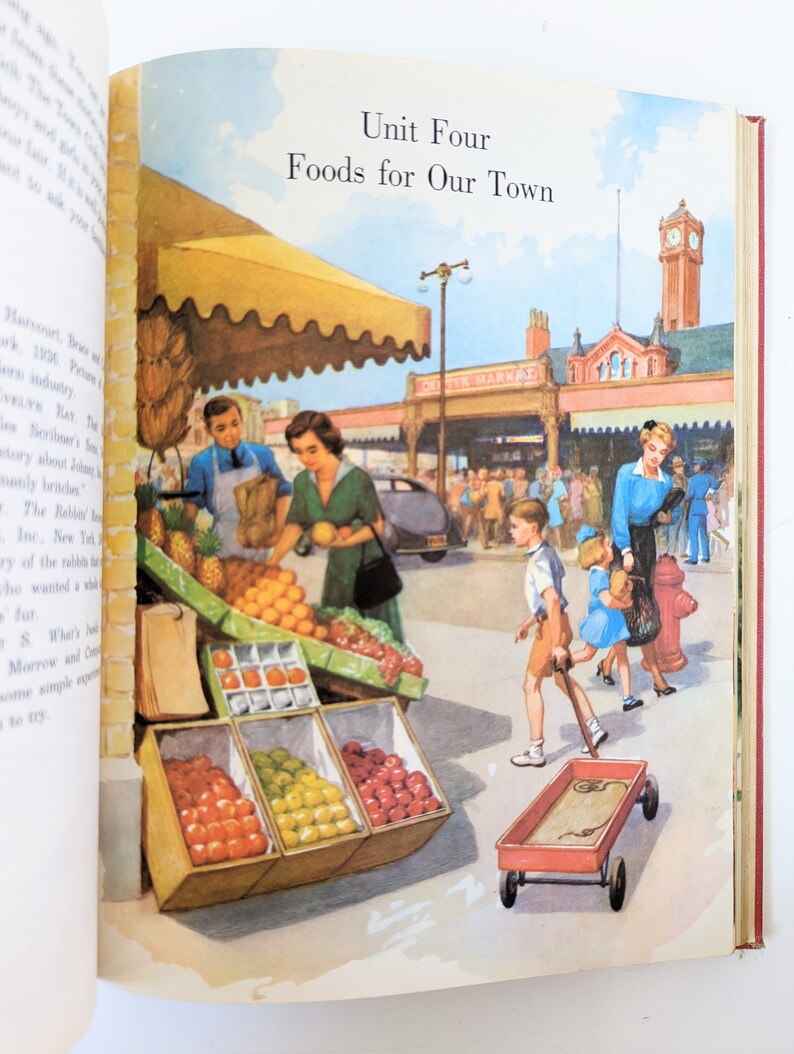 May include: A colorful illustration of a bustling outdoor market with a red wagon, fruit stands, and people walking by. The sign above the market reads "CITY MARKET".