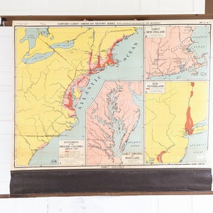 May include: A vintage educational map showing the settlements of the English colonies in North America around 1700. The map is divided into four sections: Early New England, New Netherland, Early Virginia, and Early Maryland. The map is printed on a roll and has a wooden frame.