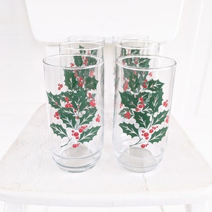 May include: Set of six clear glass drinking glasses with a holly and berry design. The glasses are perfect for holiday entertaining.