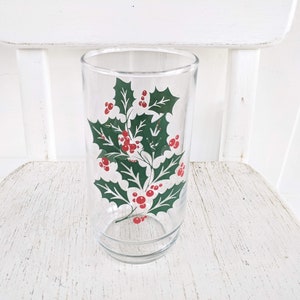 May include: A clear glass tumbler with a green holly and red berry design.