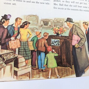 May include: A group of people are gathered around a large, wooden cabinet with a television screen. The cabinet is decorated with a floral arrangement. The people are smiling and appear to be enjoying themselves. The text on the page reads: "W come in and see the new television set.  2. W the sto a. th b. t MADO Eliza"
