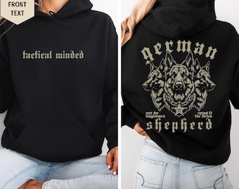 May include: A black hooded sweatshirt featuring the text tactical minded on the front and a graphic on the back showing three German Shepherd dog heads, a star, and the text German shepherd not for beginners rated D for Drive.