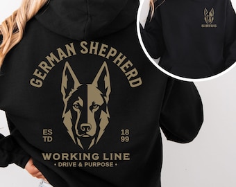 May include: A black hooded sweatshirt featuring a tan graphic of a German Shepherd head on the back with the text "GERMAN SHEPHERD", "ESTD 1899", "WORKING LINE", and "DRIVE & PURPOSE". The front chest area displays a smaller tan German Shepherd head and the word "SIRIUS".