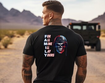 May include: Black t-shirt with a skull wearing a helmet graphic. The helmet is red, white, and blue. The text "FOR ALL MINE ILL LAY YOURS" is printed vertically on the left side of the shirt.