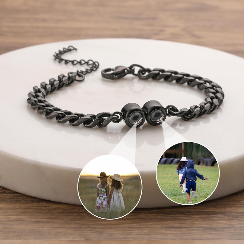 May include: A dark gray chain bracelet with a magnetic clasp. The bracelet is displayed on a white surface. Two circular inset images show children playing outdoors.