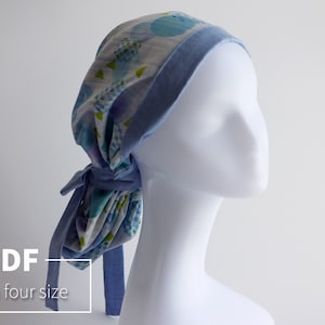 May include: A patterned head covering in blue and white, with a light blue trim and ties. The head covering is displayed on a white mannequin head. The text "PDF In four size" is visible.