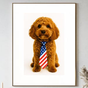 May include: A framed portrait of a brown poodle wearing a tie with the American flag design. The dog is sitting in front of a white background. The image is displayed above a wooden cabinet with decorative items.