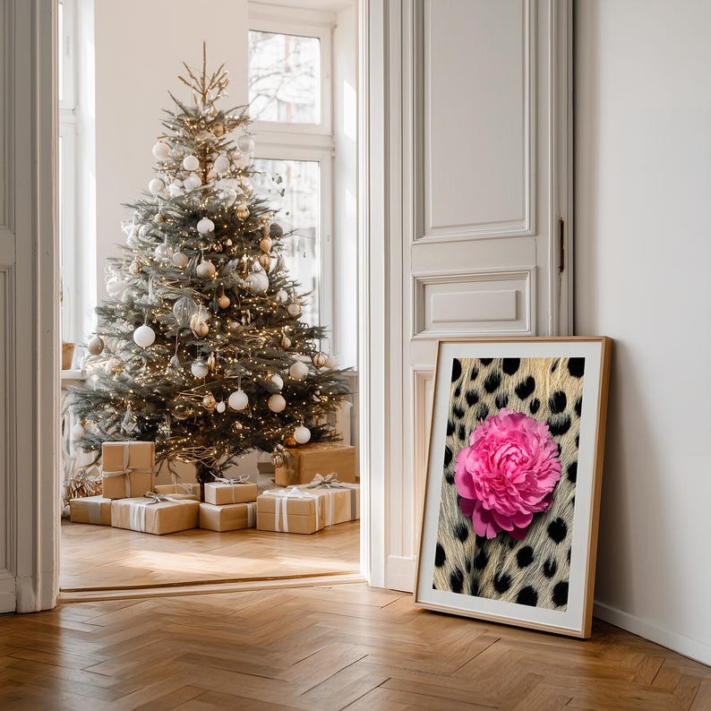 May include: A framed print featuring a vibrant pink peony against a backdrop of a leopard print pattern. The artwork is displayed in a room with a decorated Christmas tree and wrapped gifts, creating a festive atmosphere.