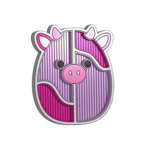 May include: A pink and purple 3D cow head with a striped pattern. The cow has a pink nose and black eyes.