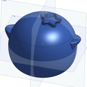 Può includere: Un contenitore in ceramica blu con un coperchio a forma di stella. Il contenitore è rotondo e ha una finitura liscia e lucida.