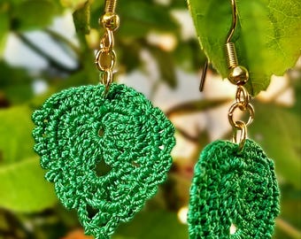 May include: A pair of green crocheted leaf-shaped earrings with gold hooks.