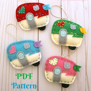 May include: Four felt camper ornaments in red, green, blue, and pink. Each camper has a white base, a gray door, and a window. The campers have different colored hearts and flags.