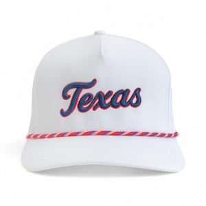 May include: White trucker hat with the word "Texas" embroidered in blue script with a red outline. The hat features a rope detail in red, white, and purple. A classic accessory.