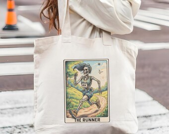 May include: Off-white tote bag featuring a tarot card illustration of a skeleton runner. The card depicts a skeleton with flowing blue hair, running on a path, with the text "THE RUNNER" at the bottom. The runner wears a race bib with the number 404.