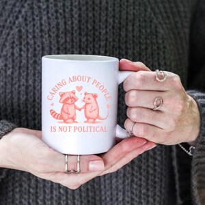 Kindness Inspirational Mug Caring About People Is Not Political Cup Vintage Raccoon Cartoon Progressive Liberal Activist Social Justice Mug