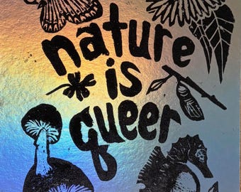 May include: A holographic print with black illustrations of a butterfly, mushroom, seahorse, and floral elements. The text "nature is queer" is prominently displayed in a bold, stylized font.