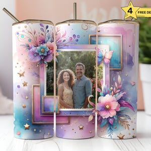 May include: Three stainless steel tumblers with a watercolor floral design and a photo frame with a couple's picture. The tumblers have gold accents and glitter.