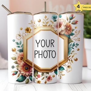 May include: Three white stainless steel tumblers with gold accents and floral designs. The tumblers have a hexagon-shaped frame with the text "YOUR PHOTO" inside. The floral designs feature pink, yellow, and blue flowers.