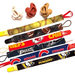 Sports Team Baby Pacifier Clip Holder, NFL NHL MLB patterns, Game Day Baby Accessory