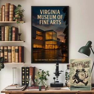 May include: A framed poster for the Virginia Museum of Fine Arts, featuring the building's exterior at dusk. The poster is displayed on a wooden desk with other items, including books and a vintage-style clock illustration.