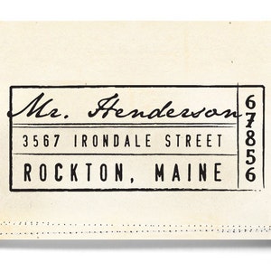 May include: Black and white vintage address label with the text "Mr. Henderson", "3567 IRONDALE STREET", and "ROCKTON, MAINE". The label has a handwritten style font and a black border.