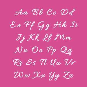 May include: A pink background displays the alphabet in a white, cursive font. The letters are arranged in rows, with uppercase and lowercase letters presented together. The font is elegant and flowing, suitable for invitations or decorative designs.